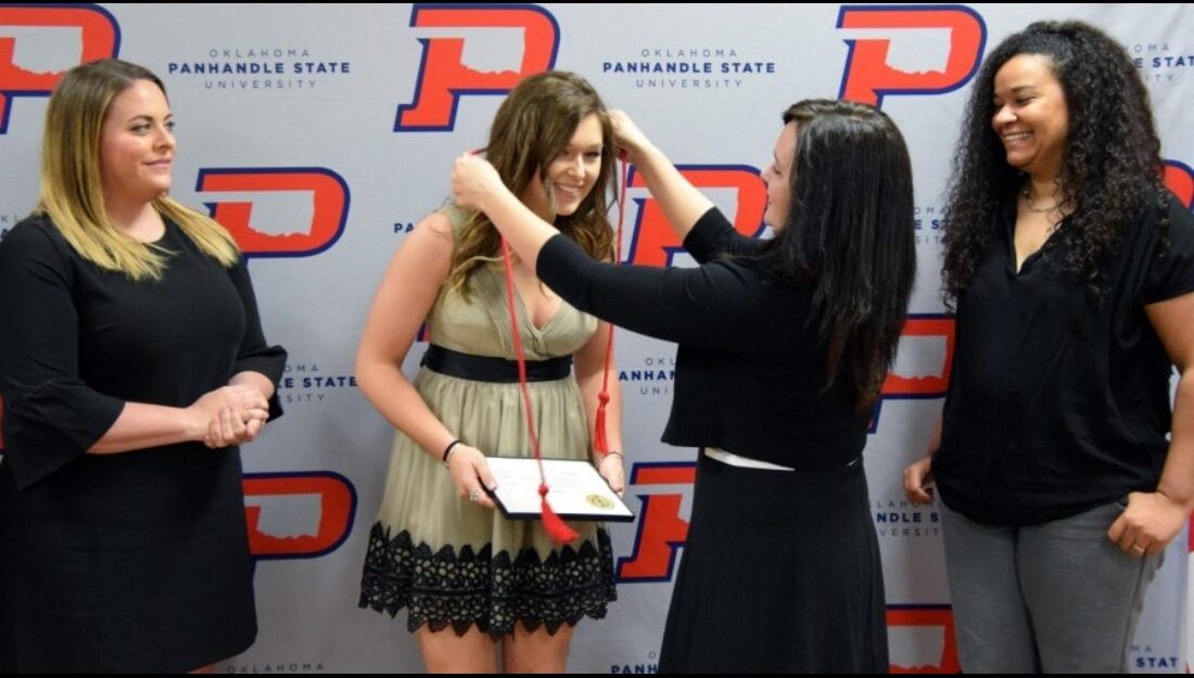 Senior Kayln Moore is presented with a red cord for graduation by Dr. Julie Dinger; also present Meghan Mulcahy, Athletic Director (left) and Head Volleyball Coach Angela Franke (right).-Sydney Dougherty photo 
