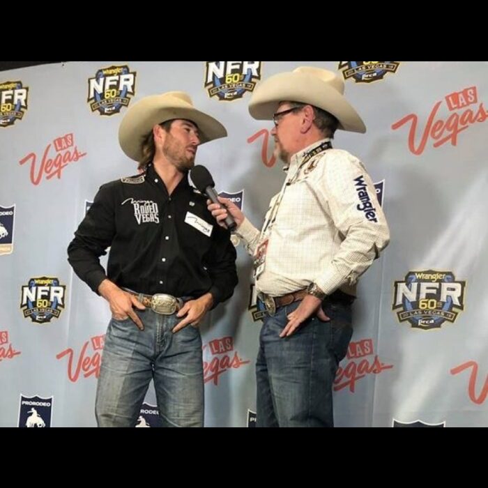 Panhandle State graduate and former Rodeo team member Cort Scheer (left) stops for an interview with Voice of the Aggies Derek Barton after claiming the top spot of the saddle bronc riding for the second night in a row on Friday, December 7, 2018. —Courtesy photo