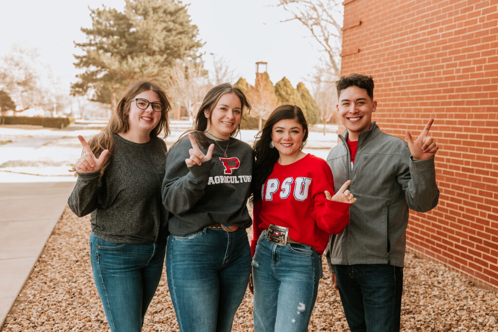 Four OPSU students posing on campus