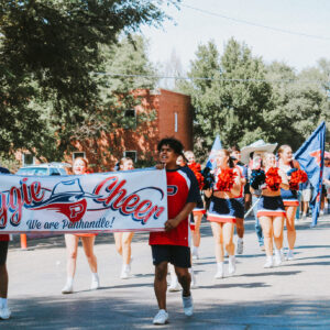 OPSU Cheer Team walking in the parade.