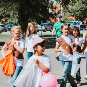 Girl Scouts handing out candy.