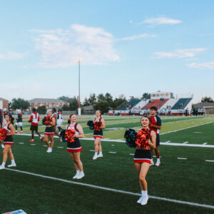 Aggie Cheer team cheering at a football game.