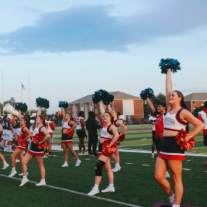 Aggie Cheer team cheering at a football game.