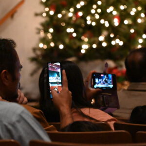 Audience members taking photos at a Chamber Singers Concert